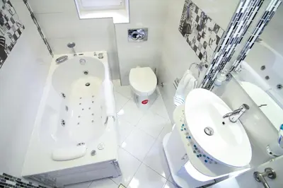 a white bathroom with a tub and a toilet at Savamala Lux Apartment in Belgrade