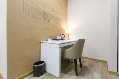 a bathroom with a sink and a chair at Hotel TESLA - Smart Stay Garni in Belgrade