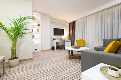 a living room with a couch and a table at Hotel TESLA - Smart Stay Garni in Belgrade