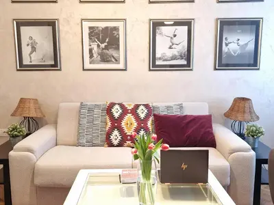a living room with a couch and a table with a laptop at Urban Downtown Apartment in Belgrade