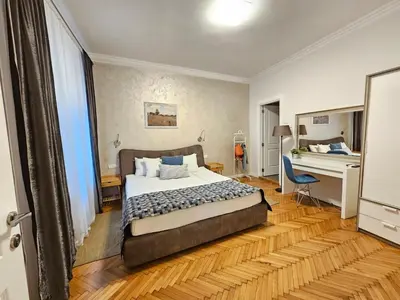 a bedroom with a bed and a desk in it at Urban Downtown Apartment in Belgrade