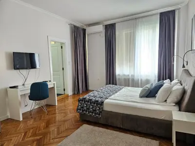 a hotel room with a bed and a television at Urban Downtown Apartment in Belgrade
