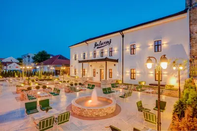 a hotel with a fountain in front of a building at Hotel Zavicaj in Belgrade