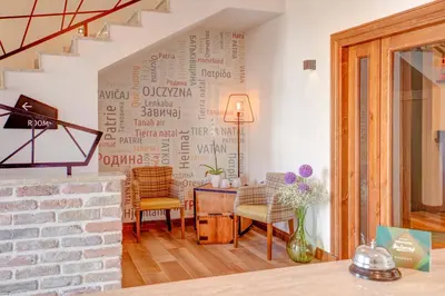 a living room with a wall with writing on it at Hotel Zavicaj in Belgrade