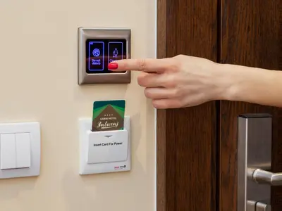a woman pressing a door button in a hotel room at Hotel Zavicaj in Belgrade