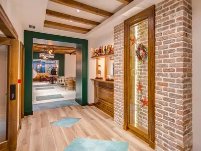 a living room with a brick wall and a door at Hotel Zavicaj in Belgrade