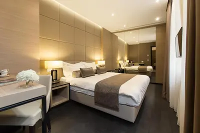 a hotel room with a large bed and a bathroom at Dominic Smart & Luxury Suites - Republic Square in Belgrade