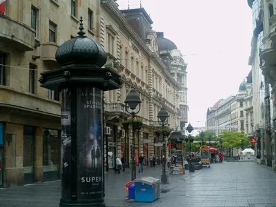a street light on a city street with buildings at Dominic Smart & Luxury Suites - Republic Square in Belgrade