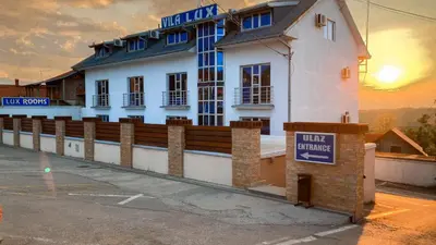 a white building with a sign in front of it at Vila Srbija Beograd in Meljak