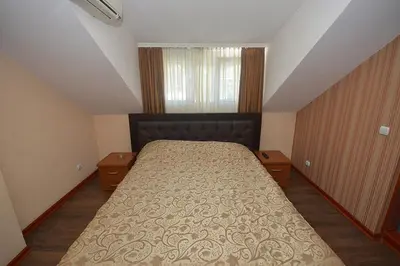 a bedroom with a large bed in a attic at Vila Srbija Beograd in Meljak