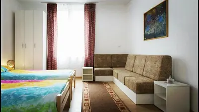 a bedroom with a bed and a couch and a bed and a window at Beograd Admiral Apartments in Belgrade