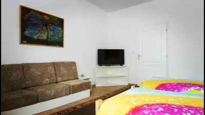 a living room with a couch and a television at Beograd Admiral Apartments in Belgrade