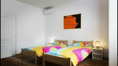 two twin beds in a bedroom with a picture on the wall at Beograd Admiral Apartments in Belgrade