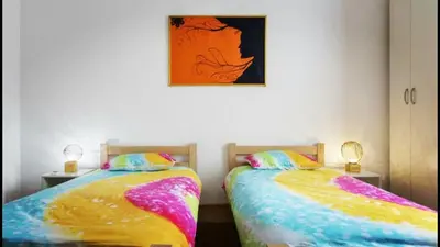 two beds sitting next to each other in a room at Beograd Admiral Apartments in Belgrade