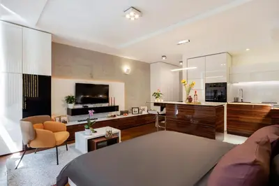 a living room with a couch and a kitchen at Leo Modern Urban Stay, Self Check-In, Free Garage in Belgrade