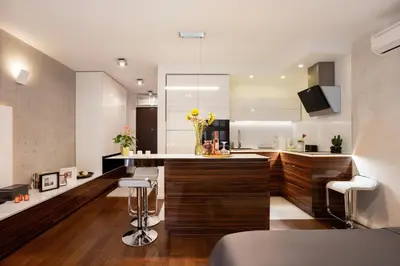 a kitchen with wooden cabinets and a counter with flowers at Leo Modern Urban Stay, Self Check-In, Free Garage in Belgrade