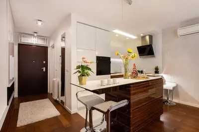 a kitchen with a counter and chairs in a room at Leo Modern Urban Stay, Self Check-In, Free Garage in Belgrade