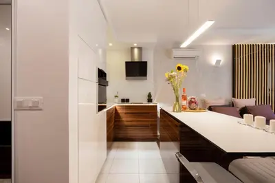 a kitchen and living room with a counter top at Leo Modern Urban Stay, Self Check-In, Free Garage in Belgrade