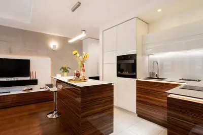 a kitchen with white and brown cabinets and a counter at Leo Modern Urban Stay, Self Check-In, Free Garage in Belgrade