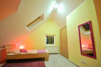 a bedroom with a bed and a mirror in a room at Apartment Sovica in Belgrade