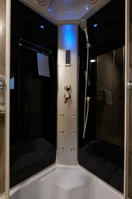 a bathroom with a shower and a shower at Airport Hotel Garni in Belgrade
