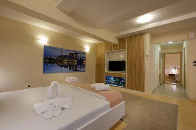 a bedroom with a bed with white towels on it at Airport Hotel Garni in Belgrade