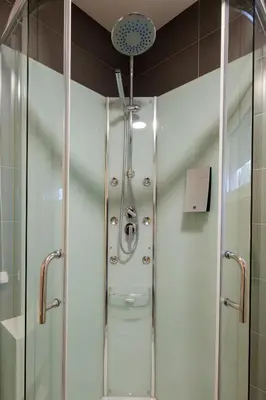 a shower with a glass door in a bathroom at Airport Hotel Garni in Belgrade