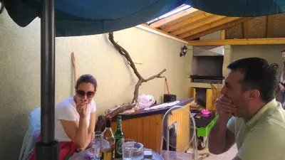 a man and a woman sitting at a table at Hostel 1910 in Belgrade