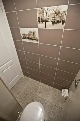 a bathroom with a toilet with a picture on the wall at Hostel 1910 in Belgrade