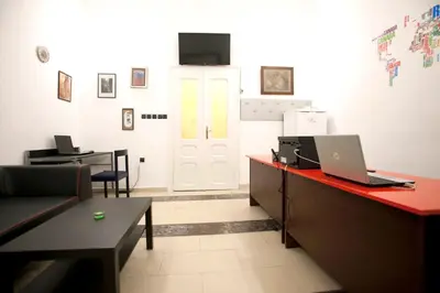 an office with a desk with a laptop on it at Hostel 1910 in Belgrade