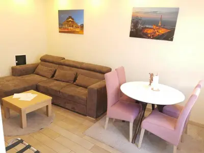 a living room with a couch and a table at 1A Moment Apartment in Belgrade