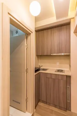a kitchen with wooden cabinets and a glass door at 1A Moment Apartment in Belgrade