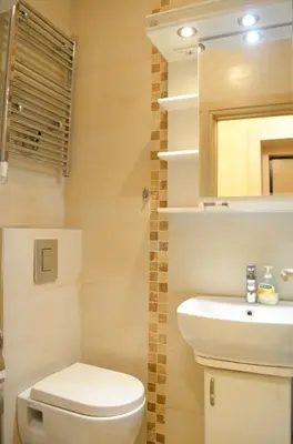 a bathroom with a toilet and a sink and a mirror at 1A Moment Apartment in Belgrade