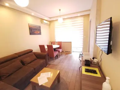 a living room with a couch and a table at 1A Moment Apartment in Belgrade