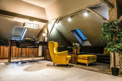 a barbershop with yellow chairs and a yellow chair at Apartments Marconio Wellness Club in Belgrade