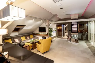 a living room with yellow furniture and a tv at Apartments Marconio Wellness Club in Belgrade