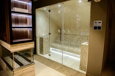 a bathroom with a shower with a glass door at Apartments Marconio Wellness Club in Belgrade