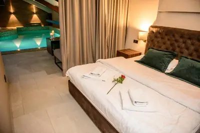 a bedroom with a large bed with two napkins at Apartments Marconio Wellness Club in Belgrade