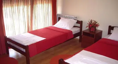 a bedroom with two beds and a window at Hostel Kavala in Belgrade