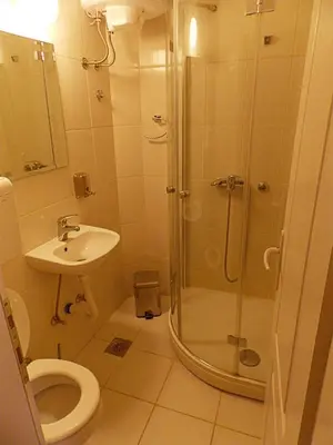 a bathroom with a shower and a toilet and a sink at Hostel Kavala in Belgrade