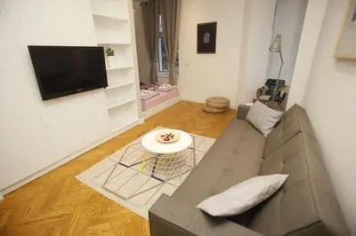 a living room with a couch and a flat screen tv at TRAMVAJ Apartments in Belgrade