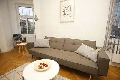 a living room with a couch and a table at TRAMVAJ Apartments in Belgrade