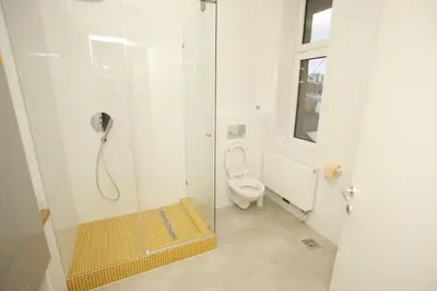 a bathroom with a shower with a toilet at TRAMVAJ Apartments in Belgrade