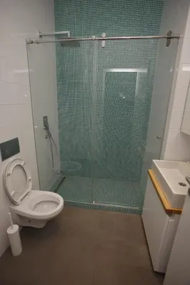a bathroom with a shower with a toilet and a sink at TRAMVAJ Apartments in Belgrade