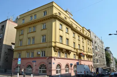a yellow building on the corner of a street at Petar Drapšin Hostel in Belgrade