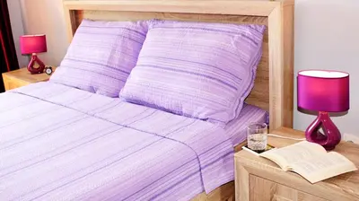 a bed with a purple comforter and a book and lamps at Kristi Lux Apartment Center Free Parking Fast WiFi in Belgrade