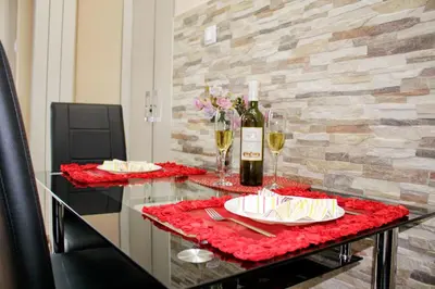 a table with glasses of wine and a plate of food at Kristi Lux Apartment Center Free Parking Fast WiFi in Belgrade