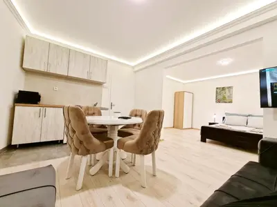 a kitchen and living room with a table and chairs at Modern Central Apartments RENOVATED in Belgrade