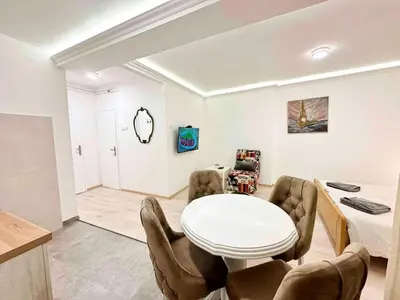 a living room with a white table and chairs at Modern Central Apartments RENOVATED in Belgrade
