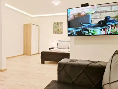 a living room with a flat screen tv on the wall at Modern Central Apartments RENOVATED in Belgrade